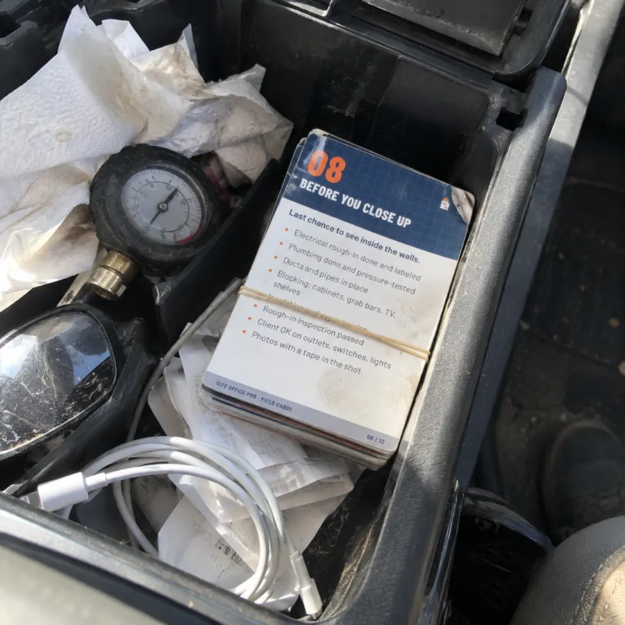 Before You Close Up field checklist kept in a contractor's truck console